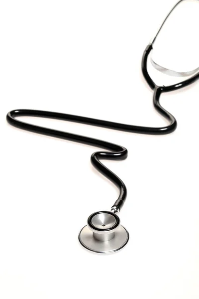 Stethoscope in the shape of heart beat isolated on white background. — Stock Photo, Image