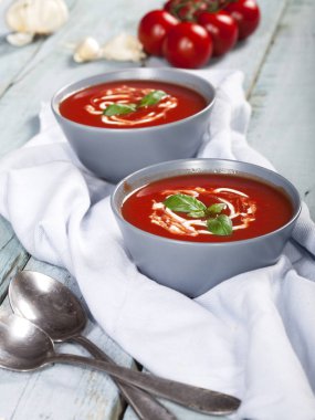 Geleneksel İspanyol soğuk domates çorbası çorbası. Mavi ahşap arka planda bir kasede..