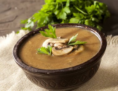 Maydanozlu lezzetli kremalı mantar çorbası ve koyu bir arka planda yakın plan..