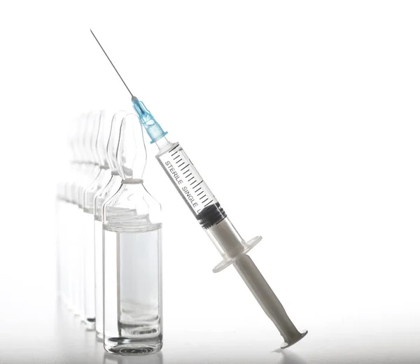 Glass medicine ampoules and Syringe on white background — Stock Photo, Image