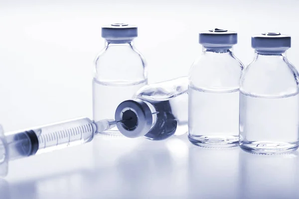 Glass medicine vials and Syringe on white background