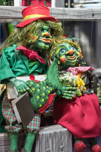 Pair of string-operated puppets (puppet) from Prague (Czech Republic). Beautiful close-up of these strange little looking people. He wore a scarf and hat, long hair, had big green eyes.