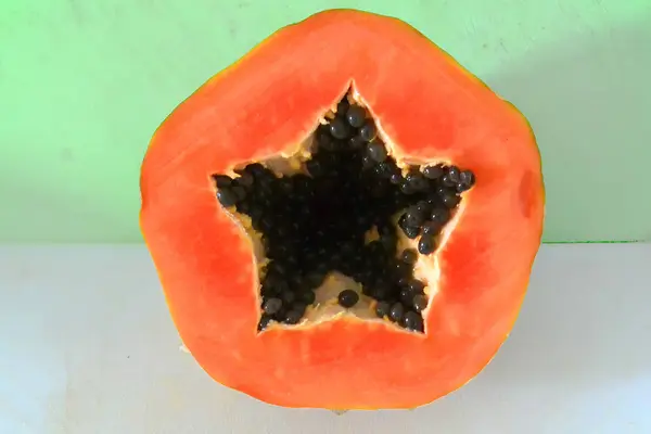 Half orange ripe papaya and seeds — Stock Photo, Image