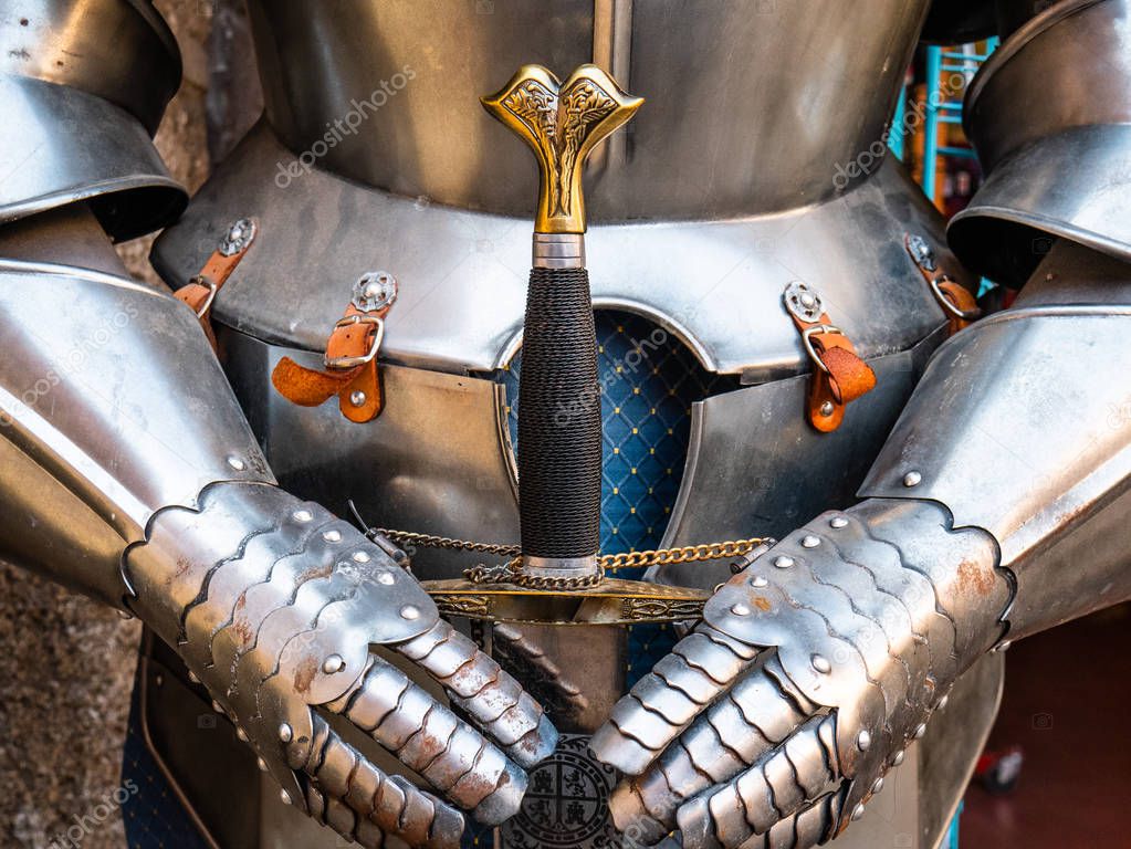 Armor of a medieval warrior holding a sword