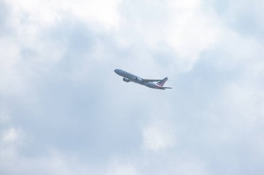 San Sebastian de los Reyes, Madrid, Spain; 03/15/2020: White plane with blue and red details of the American Airlines company with a blue sky and clouds in the background