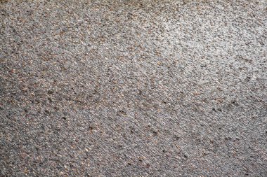 Yağmurda damlayan damlalar gibi ıslak bir yolun soyut asfalt arka planı