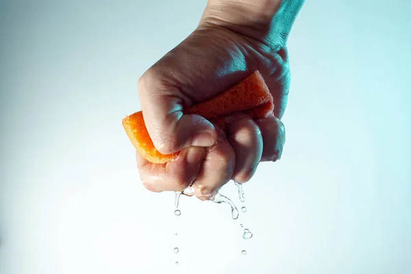 Male Hand Squeezes Sponge Washing Water Drops Fall Concept Light — 스톡 사진