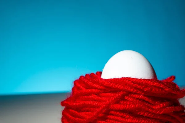 White Chicken Egg Red Threads Blue Background Close Copy Space — 스톡 사진