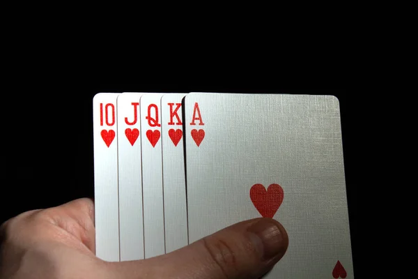 Hand Halten Royal Flush Pokerherzen Auf Schwarzem Kopierraum Hintergrund Nahaufnahme — Stockfoto