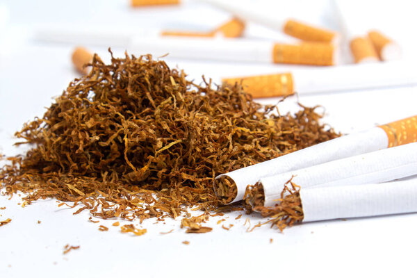 handful of tobacco and cigarette liners on a white background. isolate