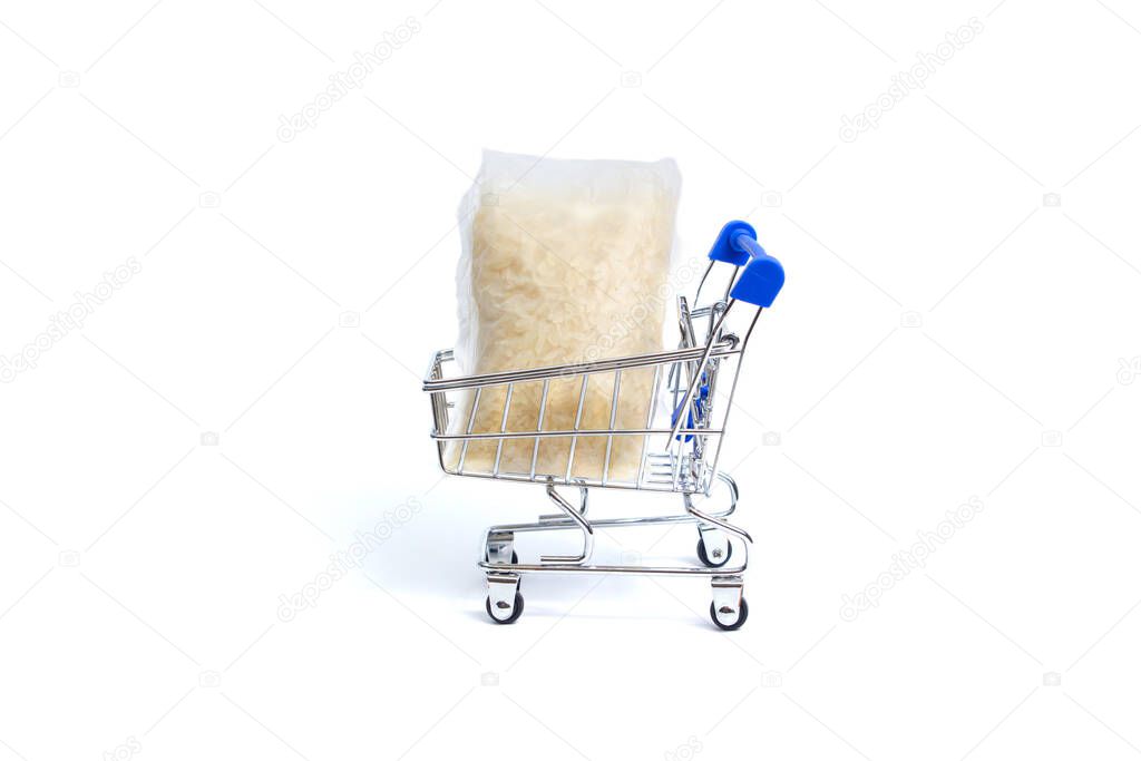 shopping cart lies two bags of rice on a white background. isolate