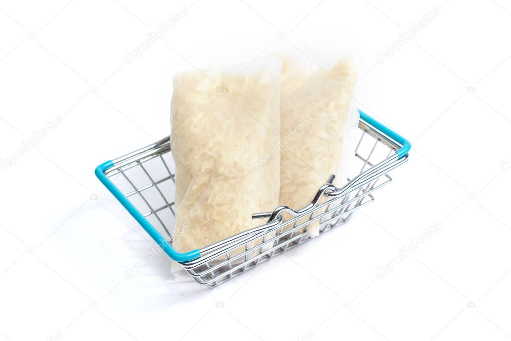 in a shopping basket there are two bags of rice on a white background. isolate