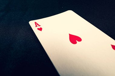 red ace of hearts on black background