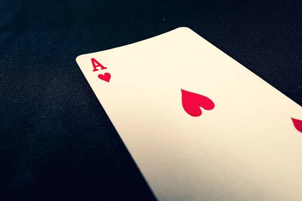 Red ace of hearts on black background — Stok fotoğraf