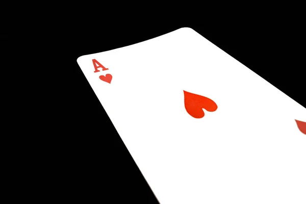 Red ace of hearts on black background — ストック写真