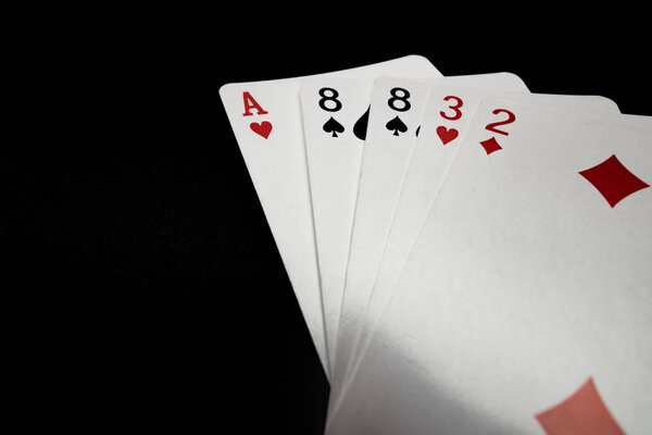 Hand of playing cards on black background