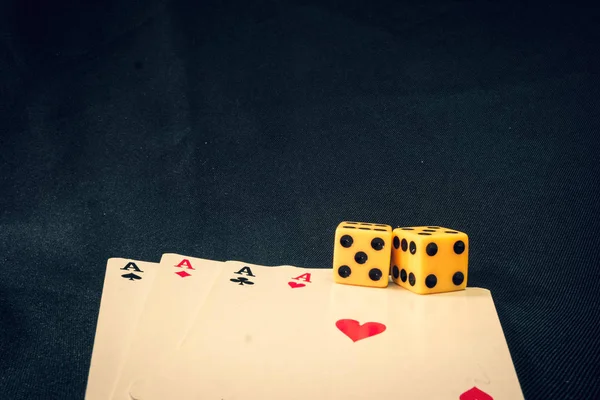 playing cards and dice on black background