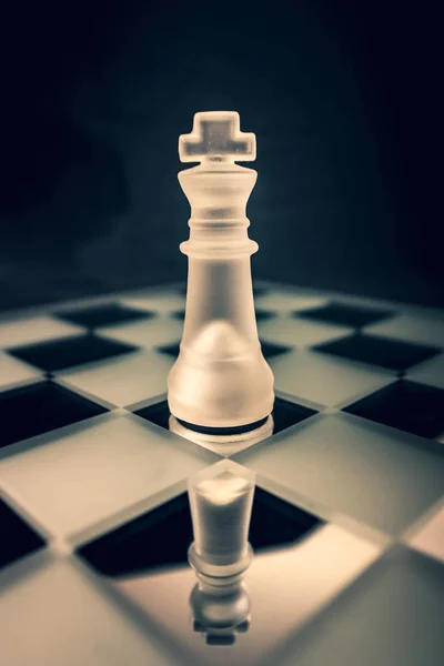 Forsted white glass King chess piece on dramatic background — Stock Photo, Image