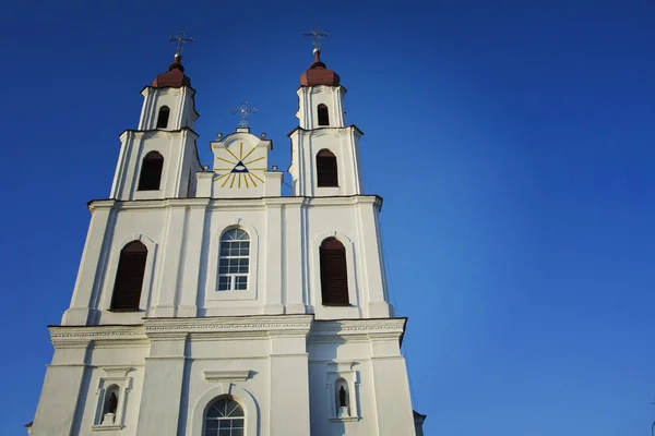 Catholic Cathedral Church with Catholic crosses on the background of blue clear cloudless sky.