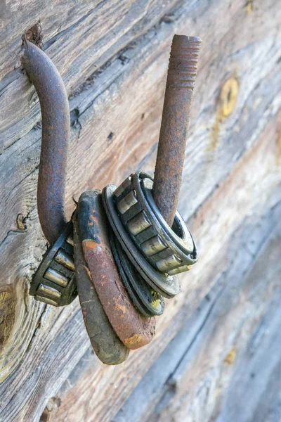 Muchos viejos rústicos resistieron gran rodillo con rodamiento de bolas en gancho de hierro, grasa seca y rodamiento roto. Textura de fondo industrial sujeciones metálicas y elementos mecánicos — Foto de Stock