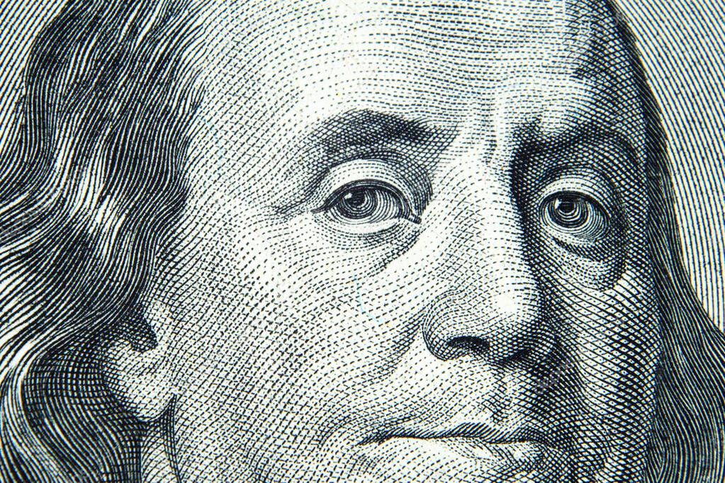 Close up view of 100 dollar banknote. US President Benjamin Franklin's portrait on one hundred dollar bill. American Dollars Cash Money.