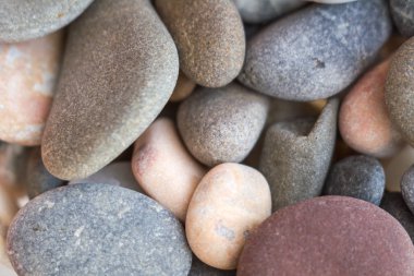 Different sizes and colors stones abstract background or texture. Closeup view. Selective soft focus