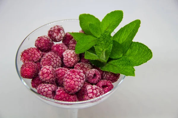 Bevroren Frambozen Met Muntblaadjes Een Witte Achtergrond — Stockfoto