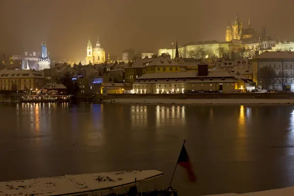 Night snowy Prague Lesser Town with gothic Castle and St. Nicholas' Cathedral,  Czech republic — Stock Photo, Image