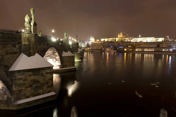 Natt snöiga Lillsidan i Prag med gotiska slott och St. Nicholas' katedral, Tjeckien — Stockfoto
