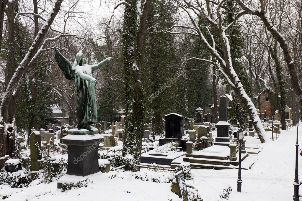 The snowy Statuel from the winter mystery old Prague Cemetery, Czech Republic