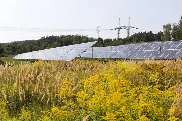 Central de energia solar no verão floração Prado — Fotografia de Stock