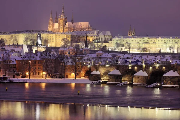 Night snowy Prague City with gothic Castle, Czech republic