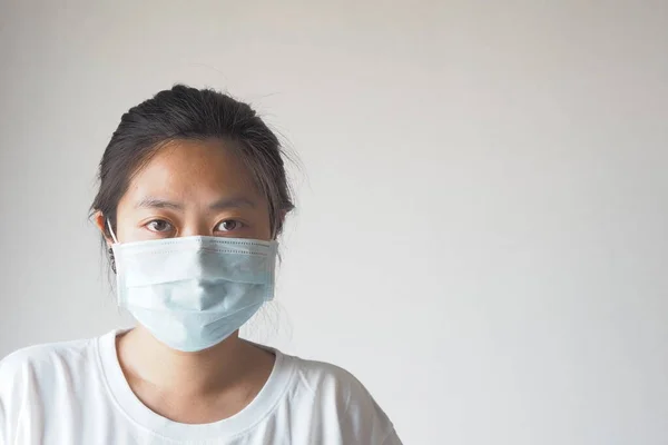 Virus mask Asian woman wearing face protection in prevention for coronavirus on white background with copy space.