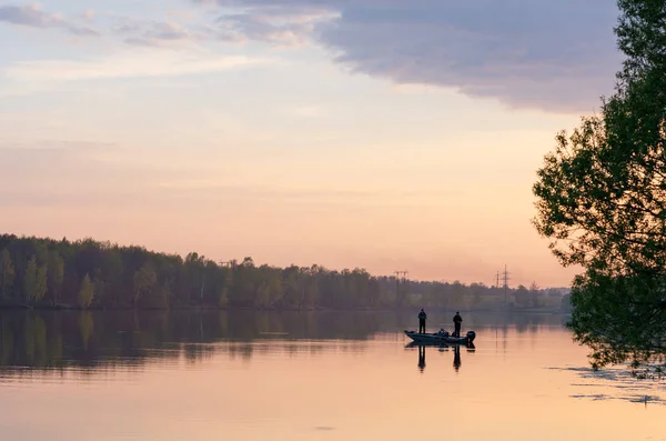 Two fisherman on boat at sunset — Stock Photo, Image