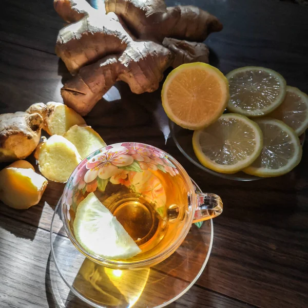 Cup of ginger tea with lemon and honey on a wooden background, top view. — Stock Photo, Image