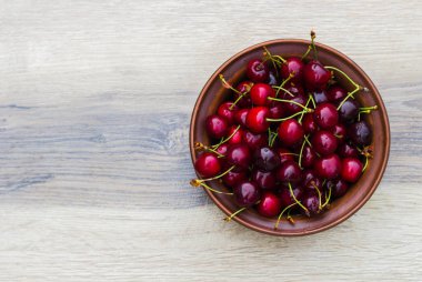 Ahşap arka planda taze kiraz tabağı. Taze kirazlar. Tatlı kirazlar. Tatlı kiraz kasesi .
