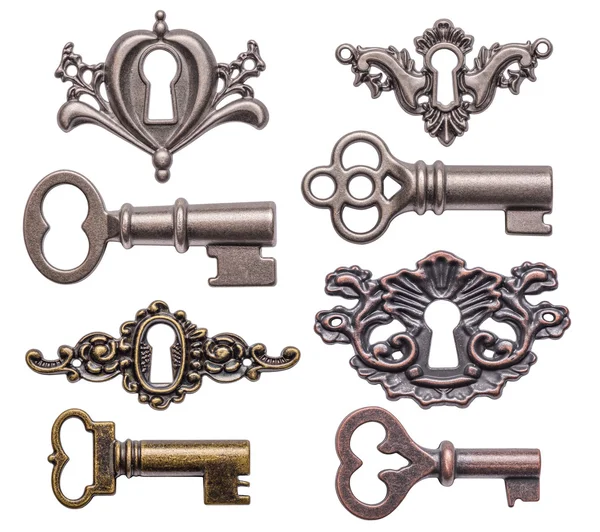 Set of old keys and keyholes isolated on white — Stock Photo, Image