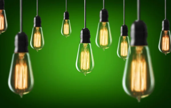 Vintage light bulbs on green background — Stock Photo, Image