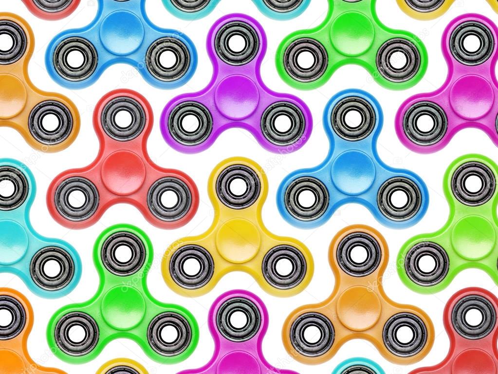 Background of colorful fidget spinners. Stress relieving toy iso
