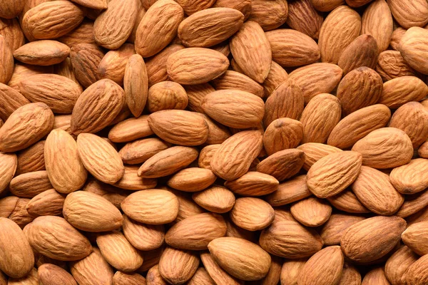 Peeled almonds closeup background. Top view — Stock Photo, Image