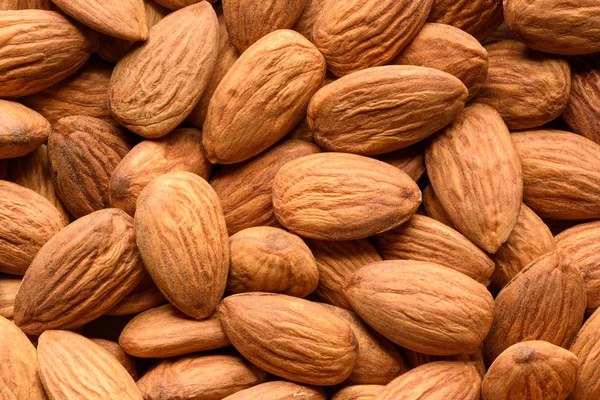 Peeled almonds closeup background. Top view — Stock Photo, Image