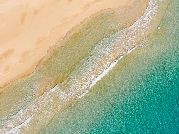 Amazing Beach and waves from top view. Turquoise water background. Summer seascape from air. Summer Background. Top view from drone. Travel concept and idea. North Cyprus, Golden Beach.