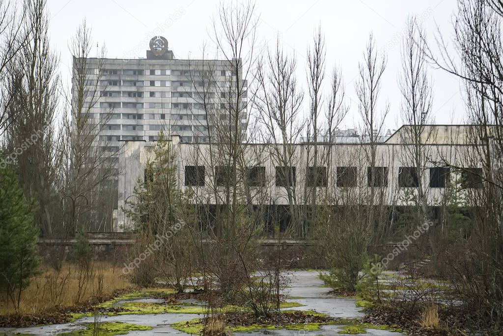 Abandoned ghost town Prypiat. Overgrown trees and collapsing buildings in Chornobyl exclusion zone. 