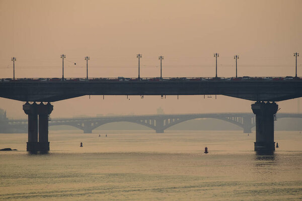 Paton Bridge and Metro Bridge over the Dnieper River in Kyiv at sunset. Kyiv. Ukraine.
