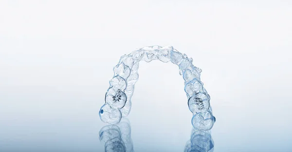 Invisible orthodontics cosmetic brackets, tooth aligners. — Stock Photo, Image