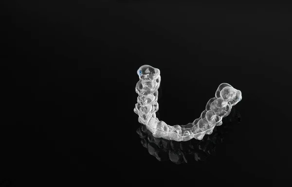 Invisible orthodontics cosmetic brackets on black background. — 스톡 사진