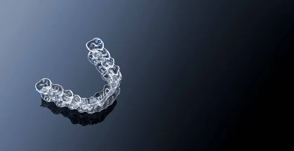 Invisible orthodontics cosmetic brackets on gradient background,