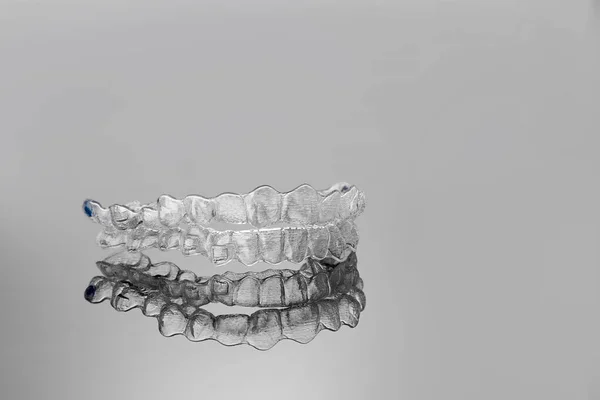 Invisible orthodontics cosmetic brackets. Tooth aligners, — Stock Photo, Image