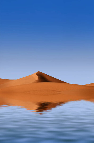 Beautiful sand dunes are reflected in the water. View of the sand dunes.