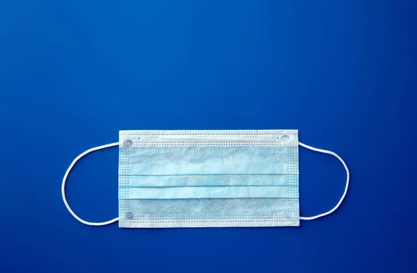 Medical mask, Medical protective mask on blue background. Disposable surgical face mask cover the mouth and nose. Healthcare and medical concept.